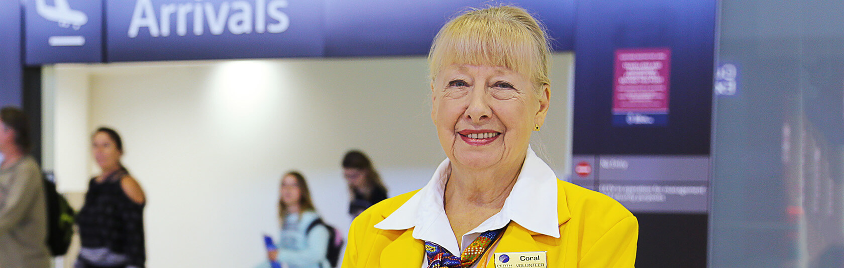 Gold Coat ambassador in the public arrivals hall at T1 International