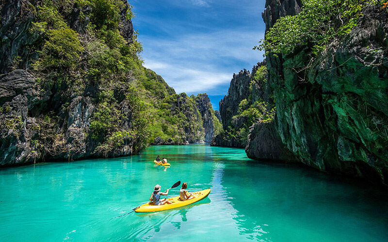 Couple kayaking in Palawan, The Philippines