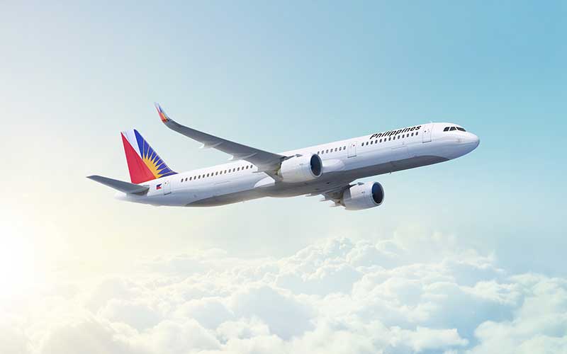 Philippine Airlines aeroplane flying above clouds