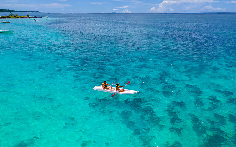 Two people kayaking in crystal-clear waters of Mauritius